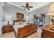 A main bedroom features a wooden bed frame and access to an outdoor kitchen area through sliding glass doors at 3866 Turtle Dove Blvd, Punta Gorda, FL 33950