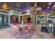 Covered outdoor dining area, featuring brick columns, chandelier, ceiling fan and access to outdoor kitchen at 3866 Turtle Dove Blvd, Punta Gorda, FL 33950