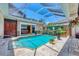 Beautifully landscaped covered pool area with waterfall feature, access to Primary bedroom, perfect for relaxing at 3866 Turtle Dove Blvd, Punta Gorda, FL 33950