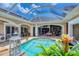 Enclosed pool area, manicured landscape, open archways, adjacent outdoor kitchen and dining, ideal for entertaining at 3866 Turtle Dove Blvd, Punta Gorda, FL 33950