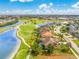 Stunning aerial view of home with private pool on golf course, showcasing lush landscaping and beautiful blue lakes at 4015 La Costa Island Ct, Punta Gorda, FL 33950