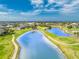 Beautiful aerial view of the lush golf course community with serene blue ponds and walking trails at 4015 La Costa Island Ct, Punta Gorda, FL 33950