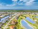 Stunning aerial shot of the home and community, situated on a golf course with tranquil ponds and beautiful canals at 4015 La Costa Island Ct, Punta Gorda, FL 33950