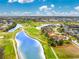 Gorgeous aerial view of a golf course community featuring ponds, mature trees, and beautifully landscaped properties at 4015 La Costa Island Ct, Punta Gorda, FL 33950