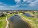 An aerial view of a lush green golf course with two ponds in a waterfront community at 4015 La Costa Island Ct, Punta Gorda, FL 33950