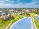 Beautiful home overlooking a golf course and a tranquil pond, complemented by mature trees and lush landscaping at 4015 La Costa Island Ct, Punta Gorda, FL 33950