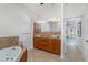 Bathroom boasts double sinks with granite countertops, a soaking tub, and access to the main bedroom at 4015 La Costa Island Ct, Punta Gorda, FL 33950