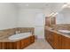 Bathroom showcases a soaking tub with tile surround, double sink vanity, and modern fixtures at 4015 La Costa Island Ct, Punta Gorda, FL 33950