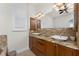 A bright bathroom featuring double sinks with granite countertops and modern fixtures at 4015 La Costa Island Ct, Punta Gorda, FL 33950