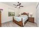 Inviting bedroom with a wooden bed frame and ample natural light from the window at 4015 La Costa Island Ct, Punta Gorda, FL 33950