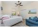Cozy bedroom featuring a ceiling fan, comfortable seating, and natural light at 4015 La Costa Island Ct, Punta Gorda, FL 33950