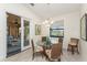 Dining area with a glass table, four wicker chairs, and a view of the water at 4015 La Costa Island Ct, Punta Gorda, FL 33950