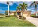 Beautiful home showcasing mature landscaping and an inviting entrance with a well-maintained lawn at 4015 La Costa Island Ct, Punta Gorda, FL 33950