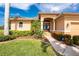 Inviting front entrance with manicured landscaping, double doors, and a well-maintained walkway at 4015 La Costa Island Ct, Punta Gorda, FL 33950