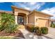 Close up view of a home's entrance with meticulously maintained landscaping, a walkway and double front doors at 4015 La Costa Island Ct, Punta Gorda, FL 33950