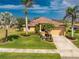 Beautiful single-Gathering home with a well-manicured lawn, lovely landscaping, and a paver driveway at 4015 La Costa Island Ct, Punta Gorda, FL 33950