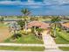 Beautiful single-Gathering home featuring a tile roof, lush landscaping, and an inviting entrance near the golf course at 4015 La Costa Island Ct, Punta Gorda, FL 33950