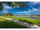 Picturesque golf course and pond with lush greenery, showcasing the natural beauty of the community at 4015 La Costa Island Ct, Punta Gorda, FL 33950
