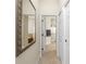 Hallway featuring tile flooring leading to a doorway and view to the ensuite bathroom at 4015 La Costa Island Ct, Punta Gorda, FL 33950