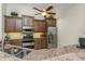 Bright kitchen with stainless steel appliances, dark wood cabinets, granite countertops, and a breakfast bar at 4015 La Costa Island Ct, Punta Gorda, FL 33950