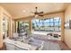 Relaxing screened-in lanai featuring comfortable seating with views of the pool, waterway, and golf course at 4015 La Costa Island Ct, Punta Gorda, FL 33950