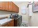 Efficient laundry room with updated appliances and extra cabinet storage at 4015 La Costa Island Ct, Punta Gorda, FL 33950