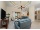 Inviting living room with modern furniture, ceiling fan, and an open floor plan leading to the kitchen and lanai at 4015 La Costa Island Ct, Punta Gorda, FL 33950