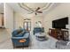 Open-concept living room with tile flooring, ceiling fan, comfortable furniture and stylish decor at 4015 La Costa Island Ct, Punta Gorda, FL 33950