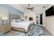 Bright main bedroom boasts a ceiling fan, stylish rug, and private access to the outdoor pool area at 4015 La Costa Island Ct, Punta Gorda, FL 33950