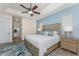 This spacious main bedroom features a modern ceiling fan, neutral decor, and comfortable furnishings at 4015 La Costa Island Ct, Punta Gorda, FL 33950