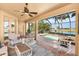 Relaxing outdoor patio features a screened-in pool with beautiful water view, ceiling fan and comfortable seating at 4015 La Costa Island Ct, Punta Gorda, FL 33950