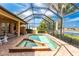 Screened-in pool and spa with patio seating and a beautiful lake view. Great for outdoor relaxation and entertainment at 4015 La Costa Island Ct, Punta Gorda, FL 33950