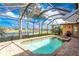 Outdoor screened-in pool and spa with brick patio, ideal for outdoor entertaining with a serene water view at 4015 La Costa Island Ct, Punta Gorda, FL 33950