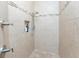 Walk-in shower with glass door and tiled walls with decorative accent tiles, and niche for storage at 4015 La Costa Island Ct, Punta Gorda, FL 33950