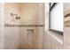 Beautifully tiled walk-in shower with built-in niche and a window for natural light at 4015 La Costa Island Ct, Punta Gorda, FL 33950