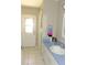 Bathroom with tiled floors, a white sink, and a door to the outside at 4309 Badali Rd, North Port, FL 34286