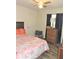 Cozy bedroom features warm wood floors, a ceiling fan, and a comfortable bed at 4309 Badali Rd, North Port, FL 34286