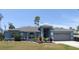 Charming single-Gathering home featuring a well-manicured lawn, mature landscaping and a two-car garage at 4309 Badali Rd, North Port, FL 34286