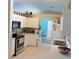 Kitchen with white cabinets and stainless steel appliances, seamlessly flowing into a cozy breakfast nook at 4309 Badali Rd, North Port, FL 34286