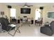 Living room area with tiled floors, ceiling fan, and an entertainment center at 4309 Badali Rd, North Port, FL 34286