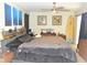 Spacious main bedroom with wood floors, ceiling fan and surf board detail at 4309 Badali Rd, North Port, FL 34286