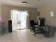 A versatile space with tiled floors and sliding glass doors to the lanai, perfect for a home office setup at 4309 Badali Rd, North Port, FL 34286