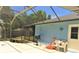 Covered patio with outdoor shower, grill, and seating area at 4309 Badali Rd, North Port, FL 34286