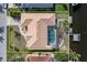Aerial view of a waterfront home with a private screened-in pool and boat dock at 5720 Almar Dr, Punta Gorda, FL 33950