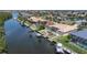Waterfront home featuring a private pool, boat dock, and lush landscaping at 5720 Almar Dr, Punta Gorda, FL 33950