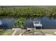 Beautiful backyard view showcasing a boat dock, canal, and mature palm trees at 5720 Almar Dr, Punta Gorda, FL 33950