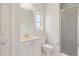 Bathroom with a white vanity, toilet, and a glass-enclosed shower, offering a clean design at 5720 Almar Dr, Punta Gorda, FL 33950