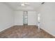 Spacious bedroom with neutral walls, tile floor, and access to bathroom and entry hallway at 5720 Almar Dr, Punta Gorda, FL 33950