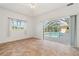 Bedroom with natural light from sliding glass doors offering views of the screened pool area at 5720 Almar Dr, Punta Gorda, FL 33950