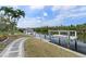 Waterfront with boat lift on a sunny day amidst lush greenery and a lovely patio at 5720 Almar Dr, Punta Gorda, FL 33950